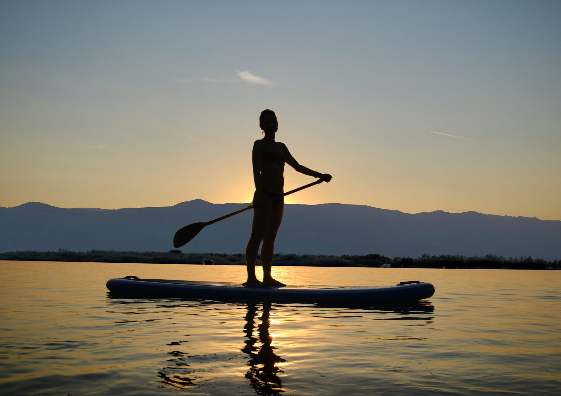 silhouette man standing sea against sky sunset kopya scaled e1760549501146